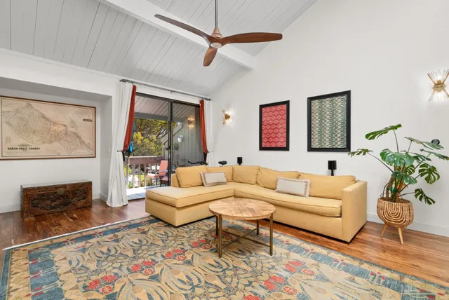 a living room with furniture a window and a flat screen tv