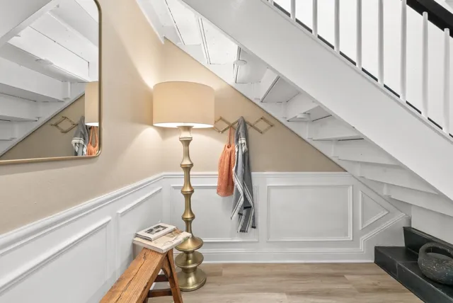 a view of entryway and hall with wooden floor
