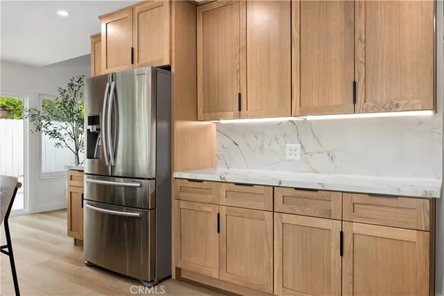 a kitchen with cabinets and stainless steel appliances