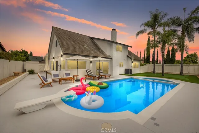 a view of a swimming pool with a lounge chairs in patio