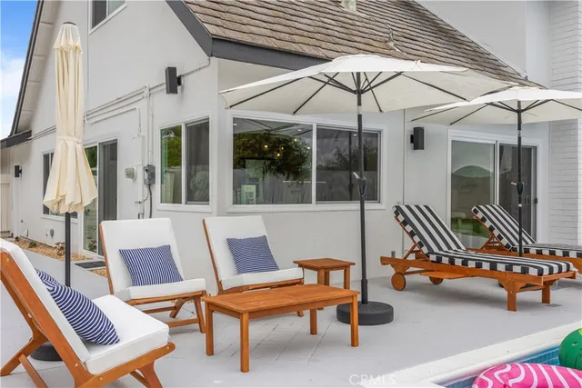 a backyard of a house with table and chairs