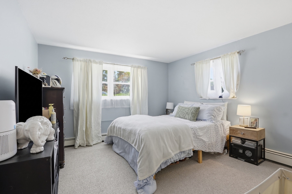 1 Colonial Drive, Unit B1 Andover, MA 01810 - Photo 8 of 14 a bedroom with a bed and a large window