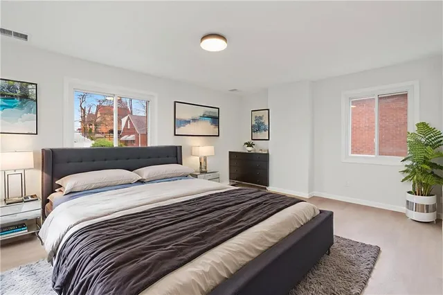 a bedroom with a bed and a couch