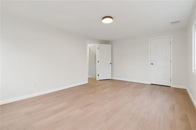 a view of an empty room and wooden floor