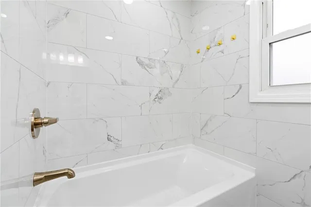 a white bath tub sitting next to a window