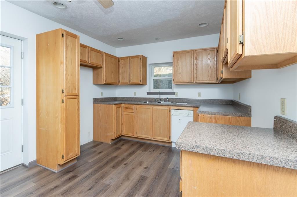 400 West Fulton Street Butler, PA 16001 - Photo 14 of 22 a kitchen with granite countertop wooden floors and wide window
