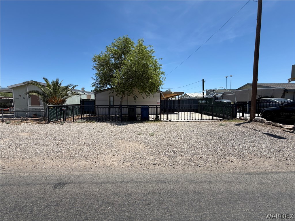 1910 Rio Grande Road Bullhead City, AZ 86442 - Photo 2 of 29 Gated property entrance featuring dual swing gates and gravel paving