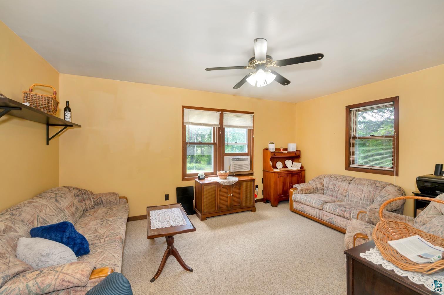 5704 Kespohl Road Floodwood, MN 55736 - Photo 10 of 26 Carpeted living room featuring ceiling fan and a wealth of natural light