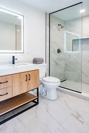 a bathroom with a sink a toilet and shower