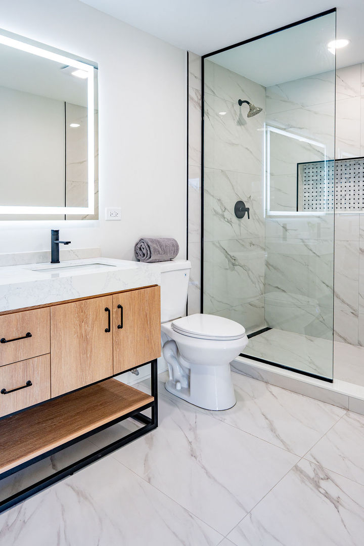 6964 West Cleveland Street Niles, IL 60714 - Photo 15 of 25 a bathroom with a sink a toilet and shower