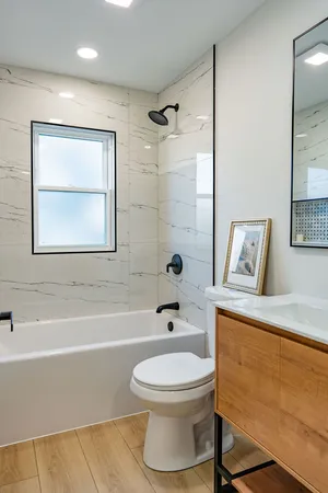 a bathroom with a toilet a sink and bathtub