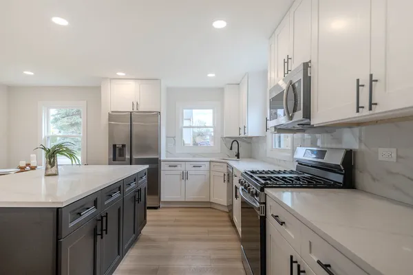 a kitchen with a sink stove and cabinets