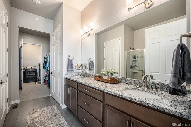 a utility room with sink dryer and washer