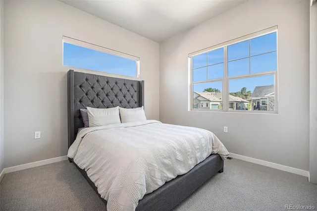 a view of a living room a dining room wooden floor and a ceiling fan