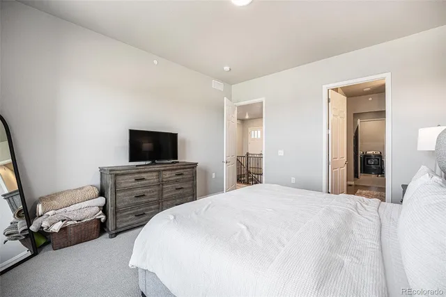 a bathroom with double vanity sinks a toilet a mirror and shower