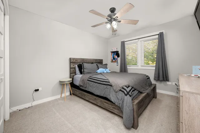 a spacious bedroom with a bed and a chandelier