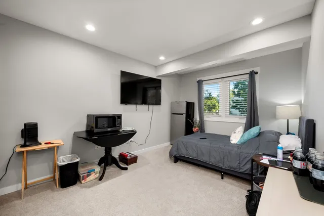 a bathroom with a granite countertop sink a mirror a vanity and shower