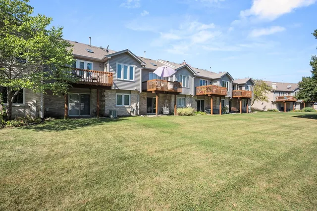 an aerial view of multiple houses with yard