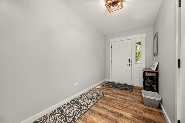 a view of a livingroom with wooden floor and a window
