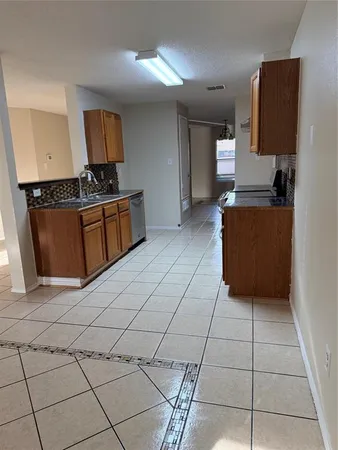 a kitchen with stainless steel appliances a sink a stove a microwave and cabinets