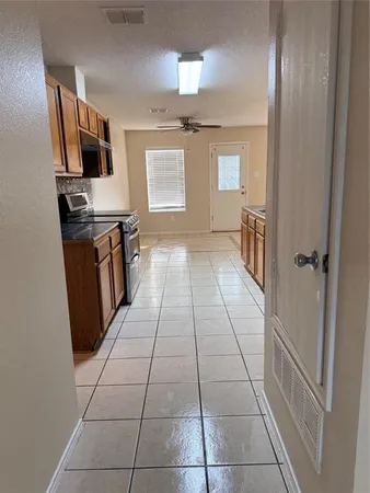 a hallway view with wooden floor and workspace