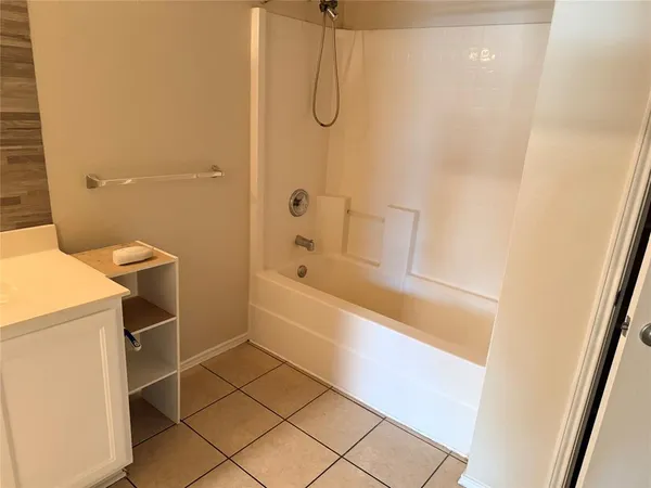 a bathroom with a granite countertop sink a toilet and shower