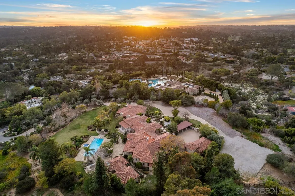 an aerial view of house with yard and mountain view in back