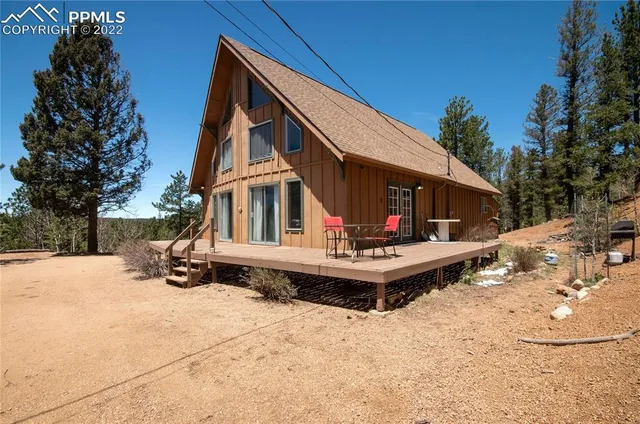a view of the house with wooden floor and snow on the road