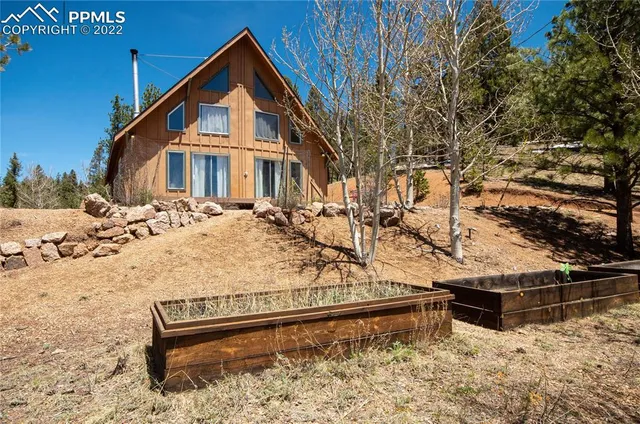 a view of a wooden house with snow on the road