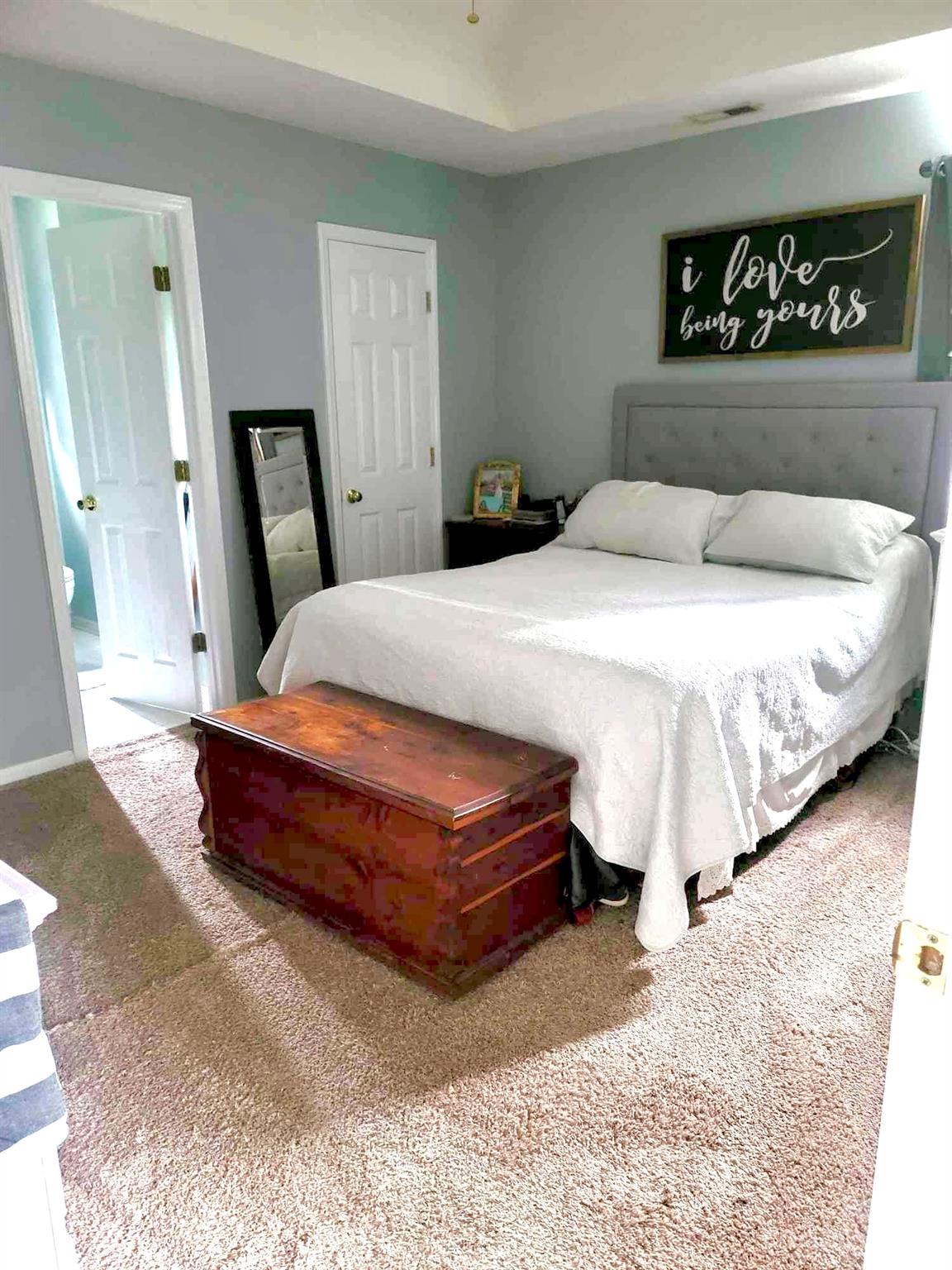 160 Hunters Pointe Drive Dallas, NC 28034 - Photo 12 of 31 a bedroom with a bed and a large mirror on dresser