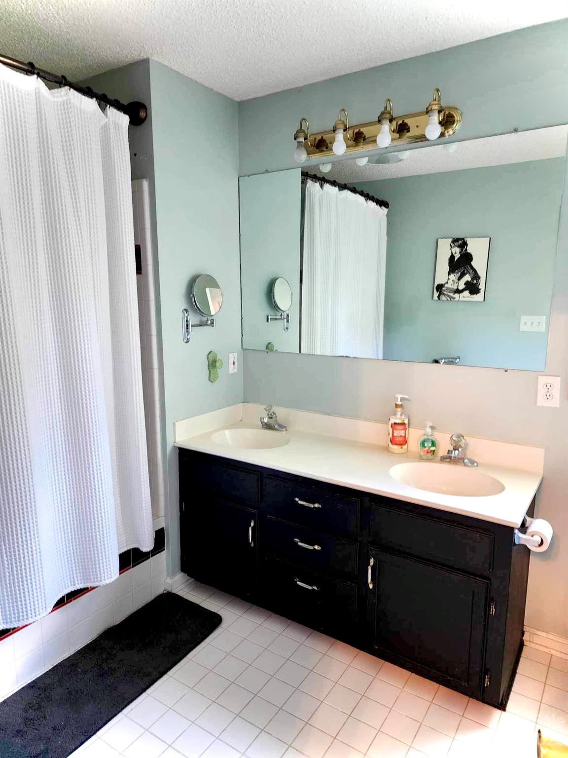 160 Hunters Pointe Drive Dallas, NC 28034 - Photo 22 of 31 a bathroom with a double vanity sink and mirror