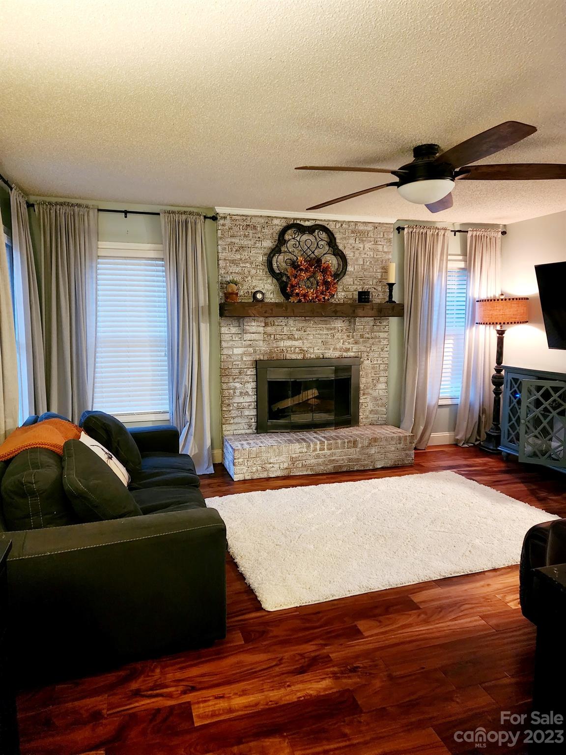 160 Hunters Pointe Drive Dallas, NC 28034 - Photo 3 of 31 a living room with furniture and a fireplace