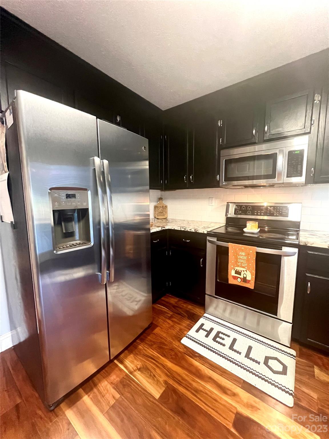160 Hunters Pointe Drive Dallas, NC 28034 - Photo 6 of 31 a kitchen with granite countertop a refrigerator and a stove top oven