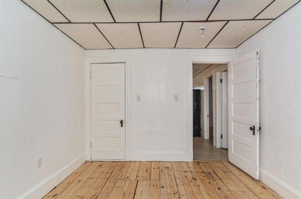 304 Pawtucket Street, Unit 2 Lowell, MA 01854 - Photo 11 of 16 a view of a room with wooden floor and a ceiling fan