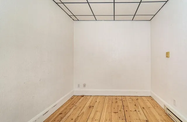 a view of a room with wooden floor