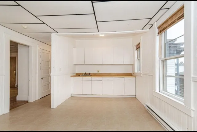 a view of a bathroom with a tub and a window
