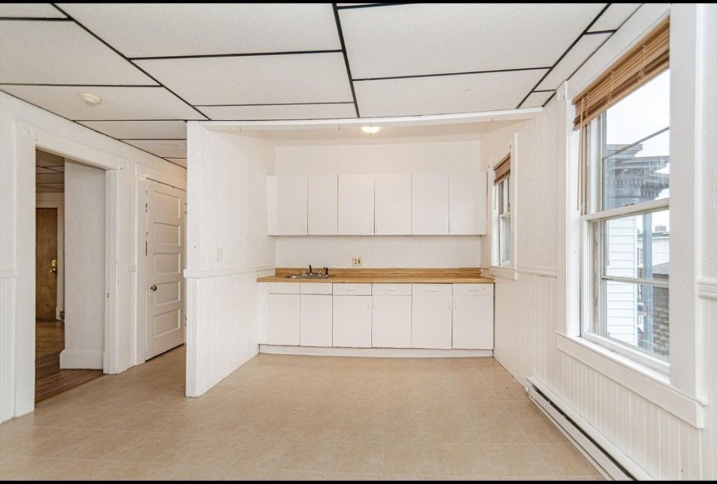 304 Pawtucket Street, Unit 2 Lowell, MA 01854 - Photo 5 of 16 a view of a bathroom with a tub and a window
