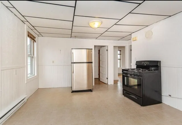 a kitchen with refrigerator and stove