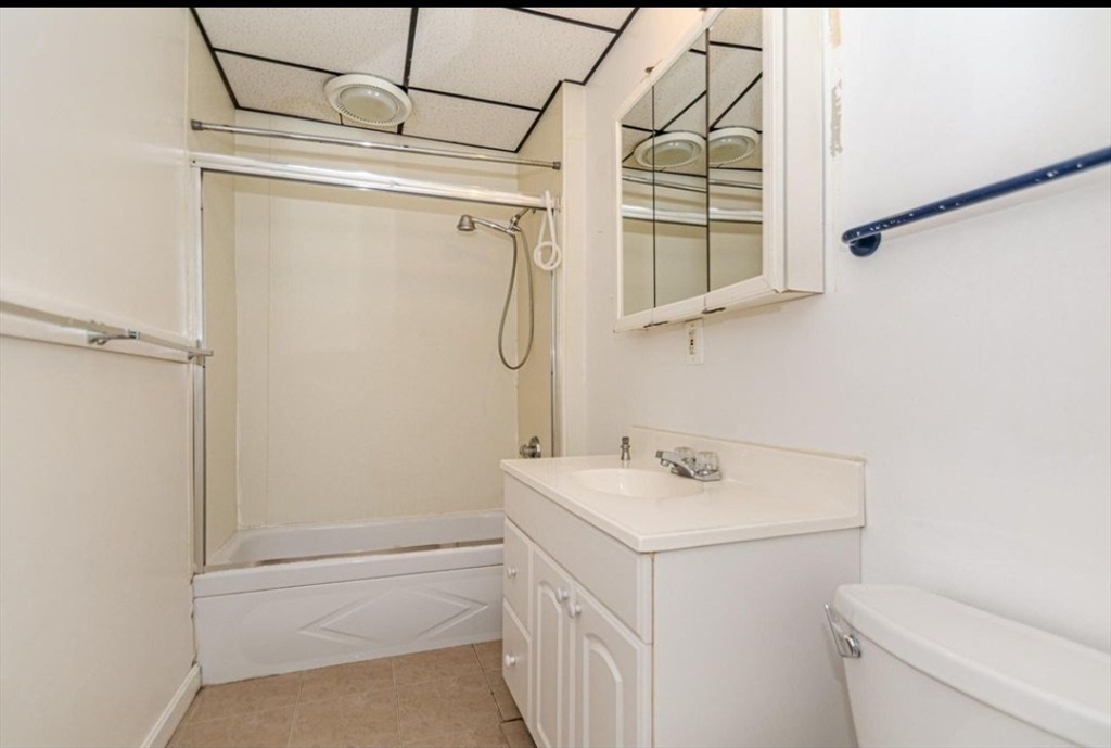 304 Pawtucket Street, Unit 2 Lowell, MA 01854 - Photo 7 of 16 a bathroom with a sink a toilet and shower