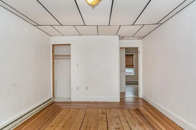 a view of a room with wooden floor