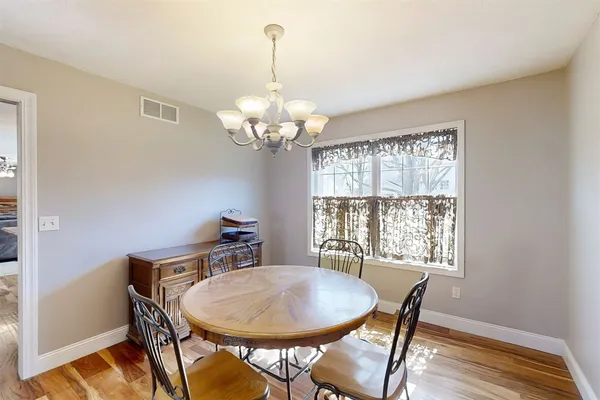 a view of a dining room with furniture wooden floor and chandelier