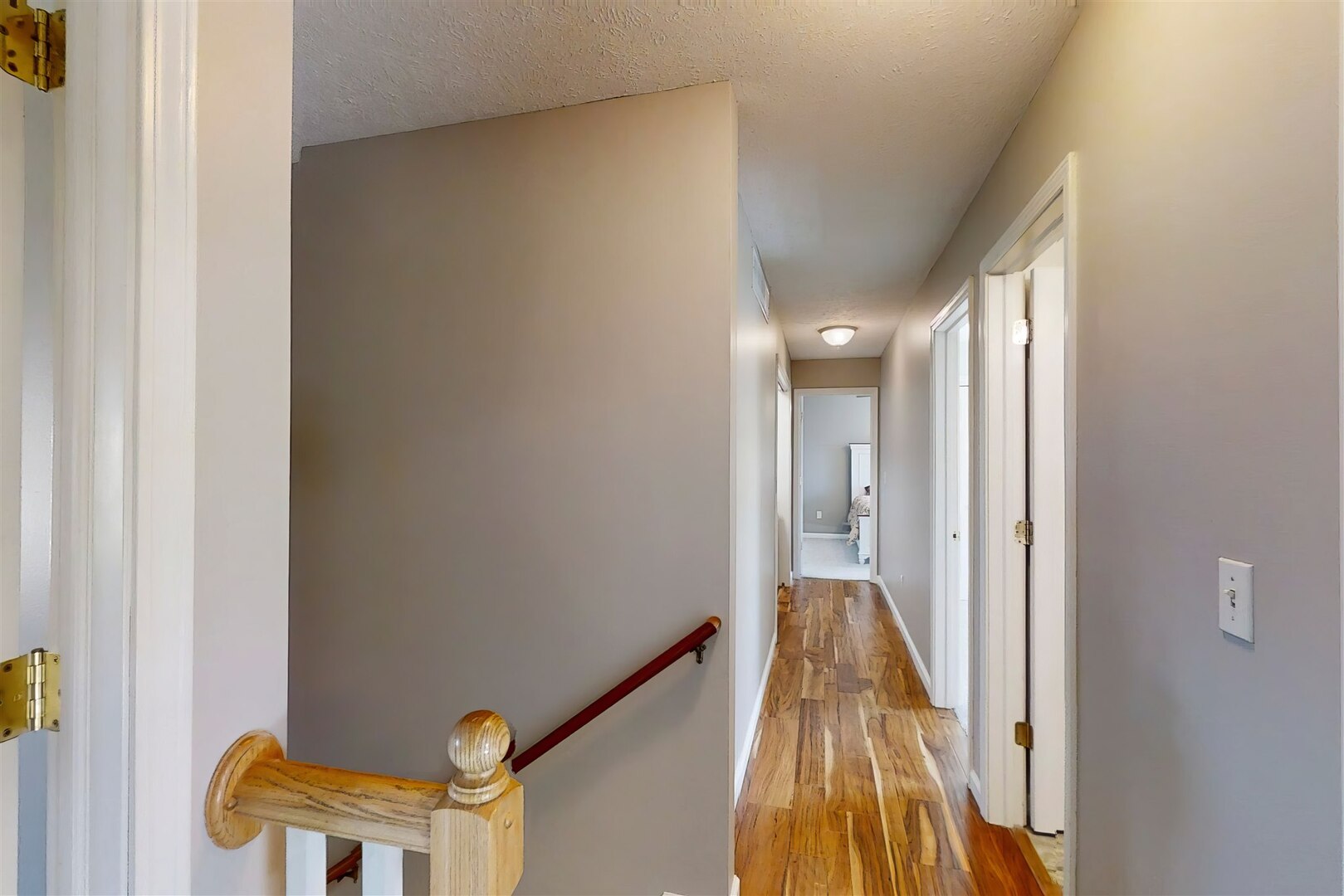 3291 Red Jasper Street Normal, IL 61761 - Photo 29 of 48 a view of a hallway with wooden floor and a bathroom