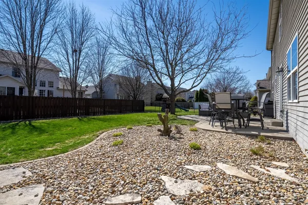 a backyard of a house with table and chairs