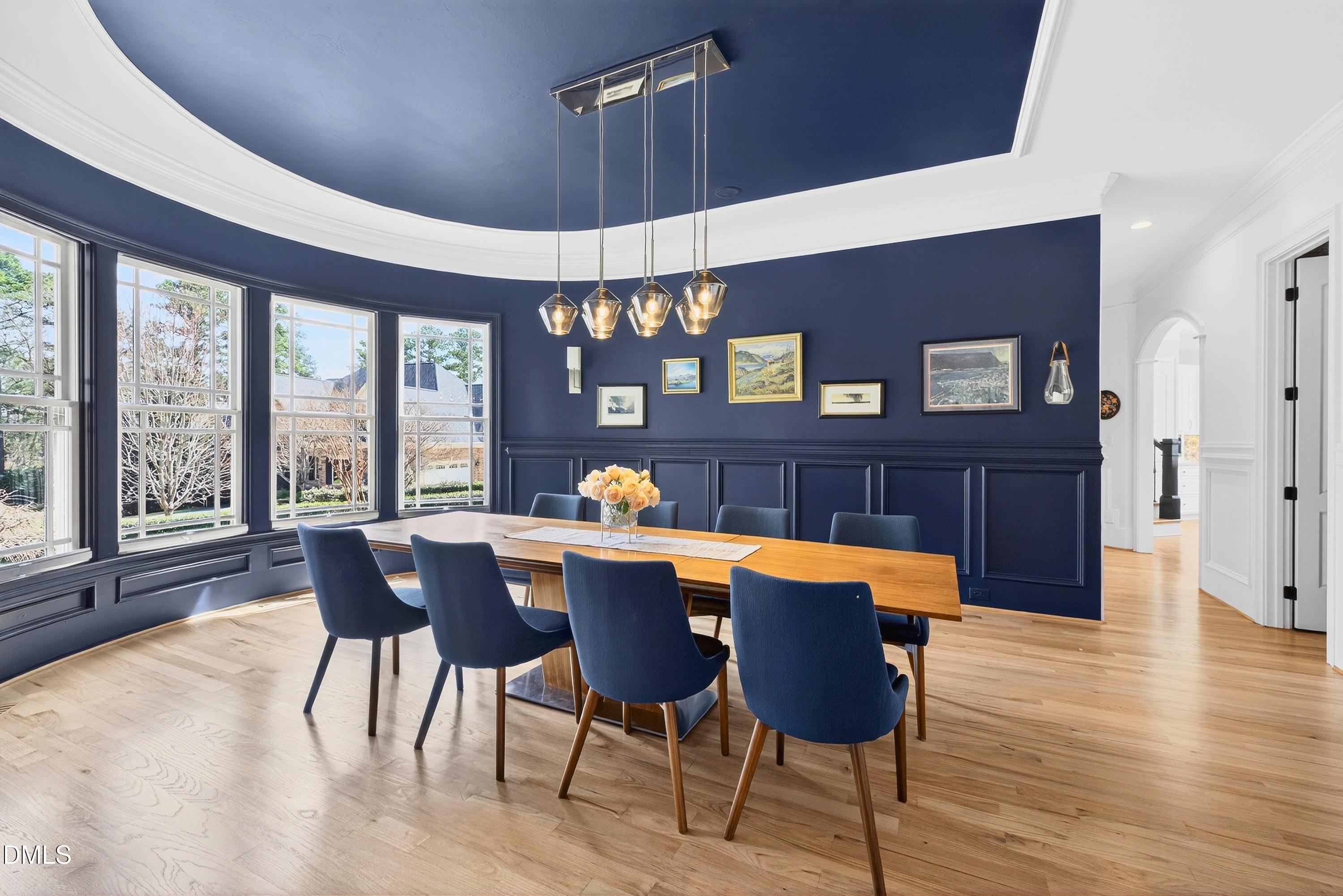6701 Foxfire Place Raleigh, NC 27615 - Photo 30 of 67 a dining room with furniture a chandelier and wooden floor