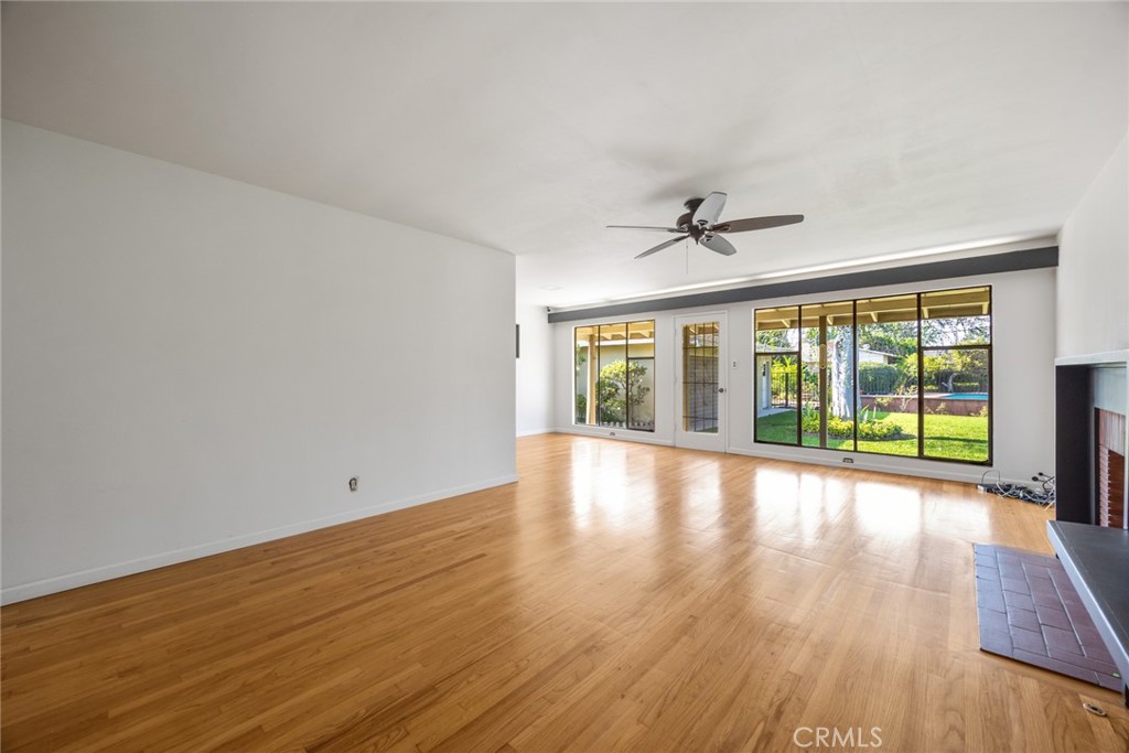 10357 Lesterford Avenue Downey, CA 90241 - Photo 5 of 31 The living room at 10357 Lesterford Avenue looks out onto the beautiful yard, swimming pool, and formal dining area.