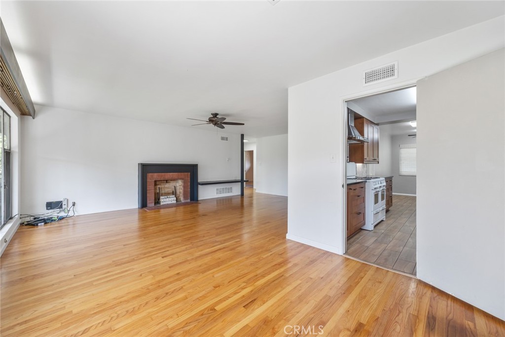 10357 Lesterford Avenue Downey, CA 90241 - Photo 6 of 31 Looking out from the dining room at 10357 Lesterford Avenue onto the living room fireplace, the yard and the pool.