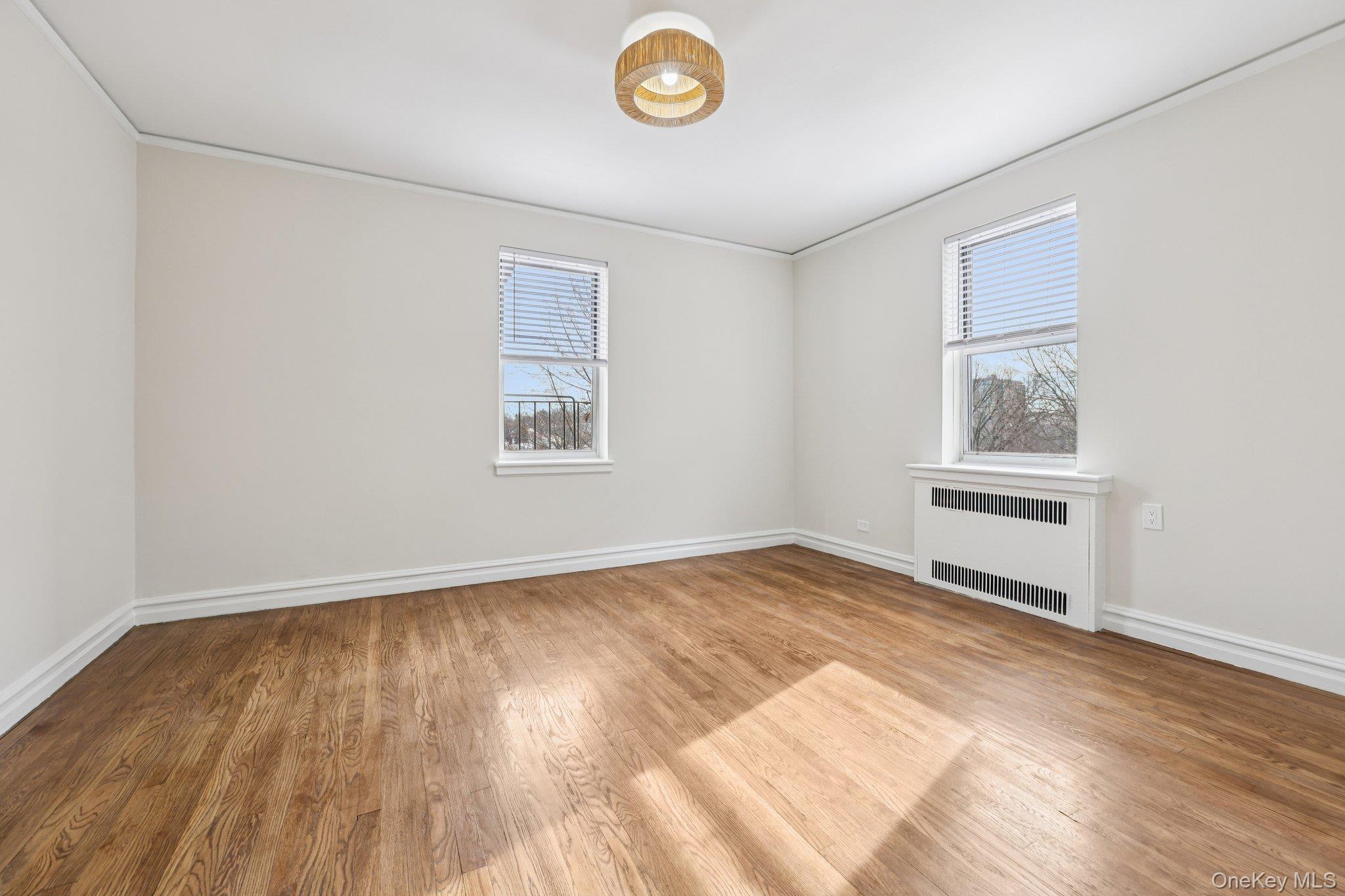 1 Bronxville Road, Unit 3S Bronxville, NY 10708 - Photo 17 of 27 featuring radiator, light wood-type flooring, and crown molding