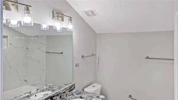 a bathroom with a mirror and a shower