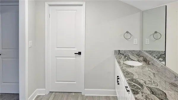 a bathroom with a granite countertop shower and a sink