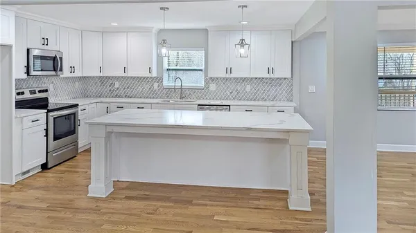 a kitchen with a stove and a sink